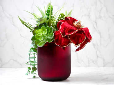 Velvet Red Passion luxury faux flower centerpiece featuring a flocked red velvet magnolia in a hand-blown red glass vase, handmade in McKinney Texas.