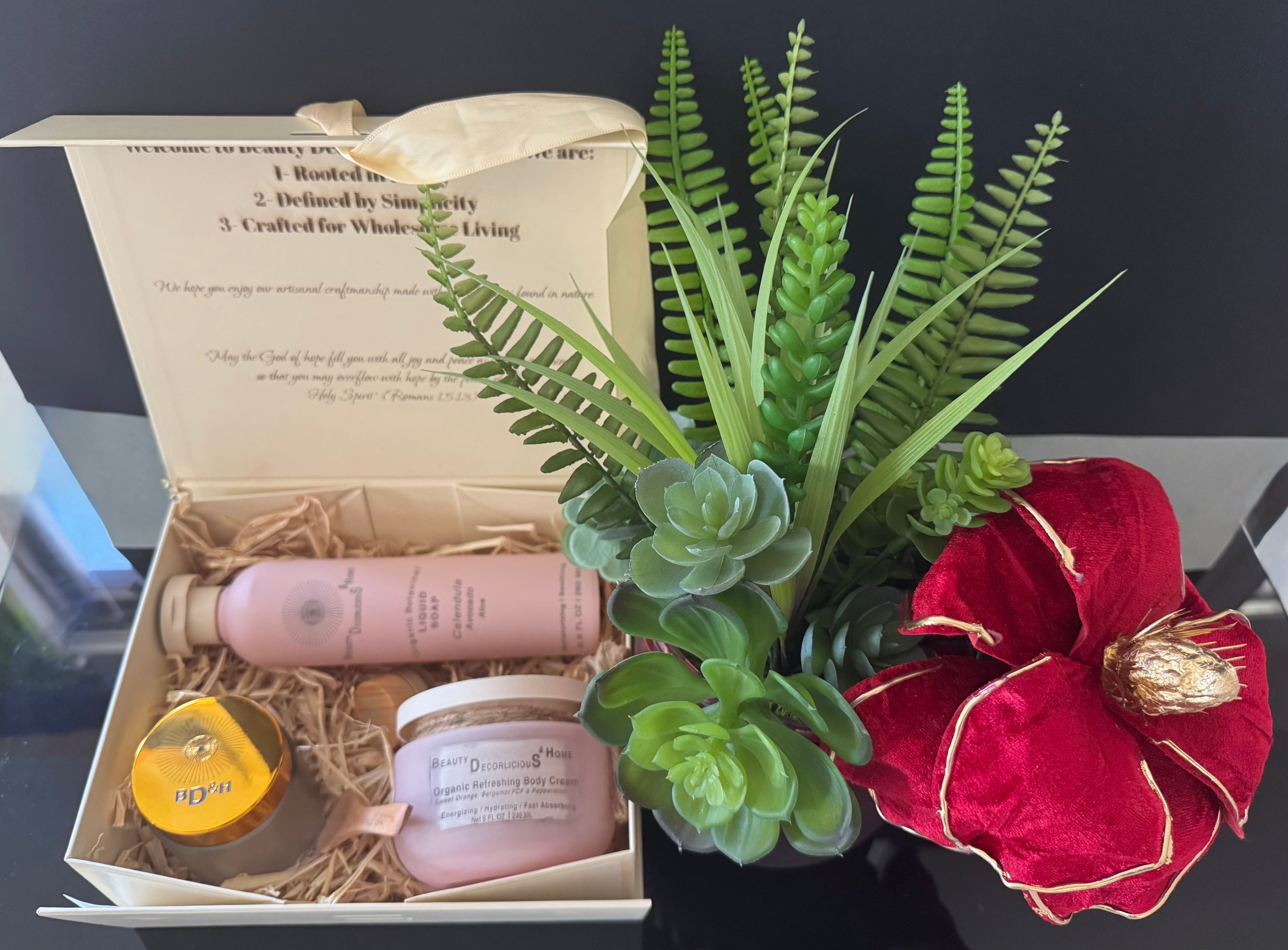 Curated luxury velvet gift box with a striking red velvet magnolia and realistic succulents centerpiece, paired with 100% anhydrous, organic skincare items—each hand-poured and crafted locally right here in Texas for an unforgettable luxury gifting experience.